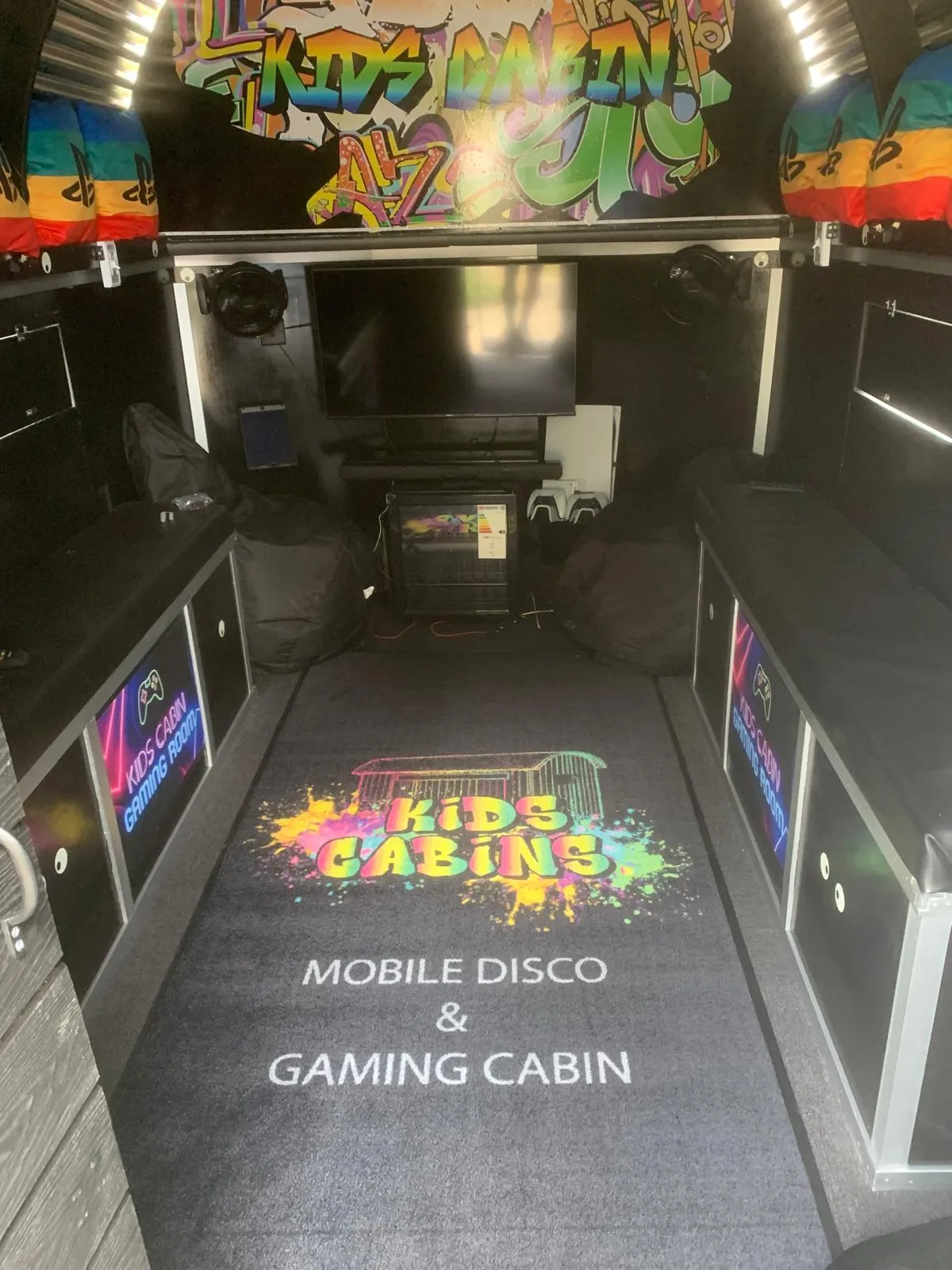 Gaming setup with PlayStations and big screens